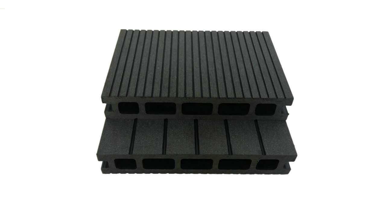 Overhead flat-lay of two stacked dark charcoal grooved composite deck boards on a white surface