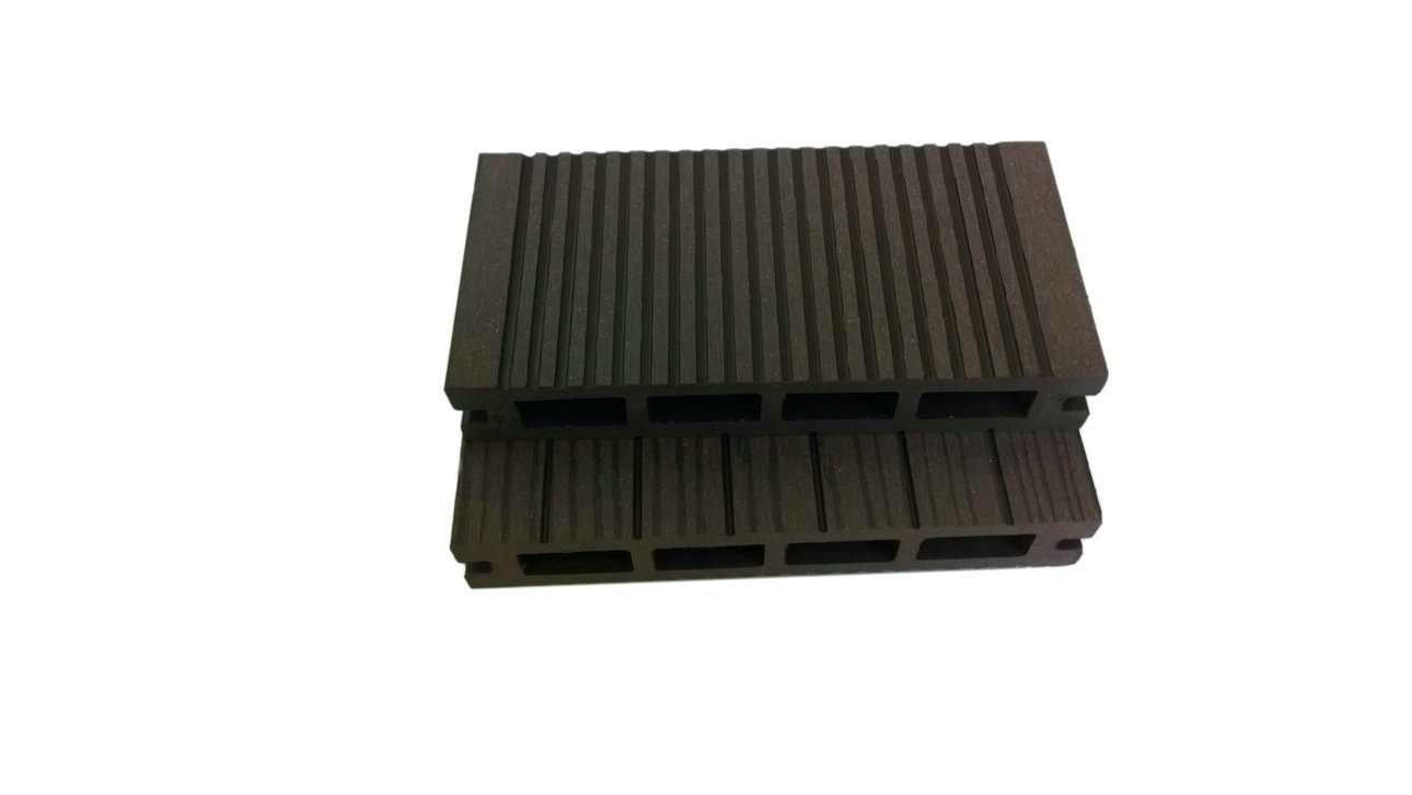 Overhead flat-lay photograph of two stacked dark brown grooved composite decking boards on a white background, showing hollow channel cross-section in deep espresso brown