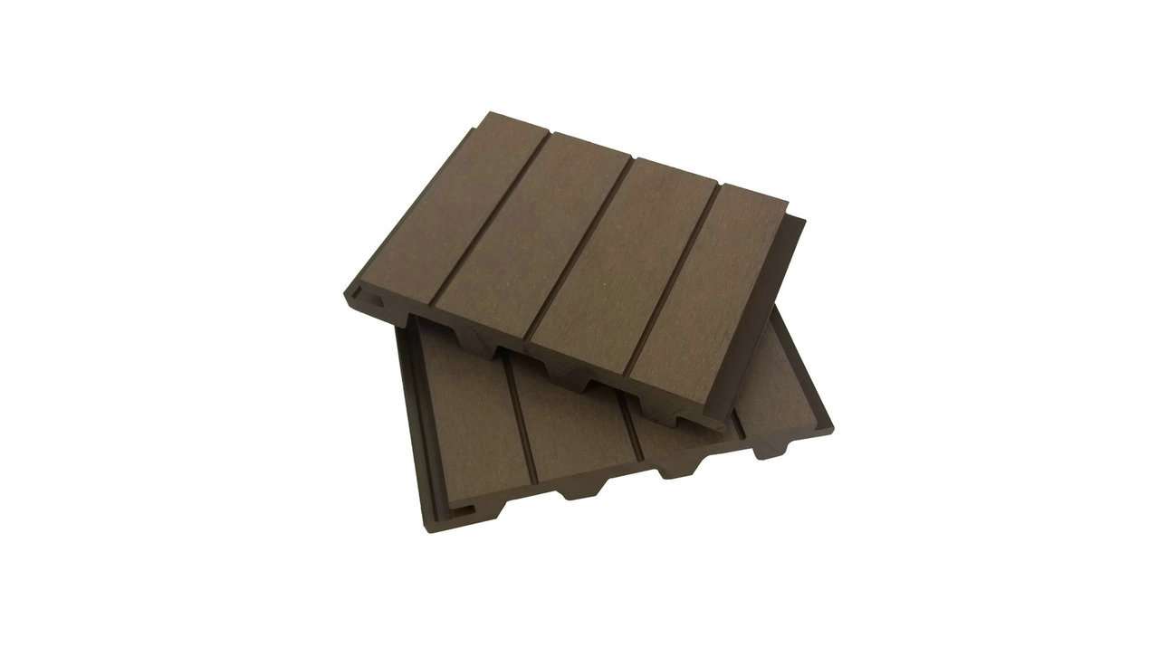 Overhead flat-lay photograph of two stacked brown composite decking boards with grooved surface and hollow chambers, shown at an angle on white background, directional soft light, russet and cocoa tones with a hands-on material-study mood.